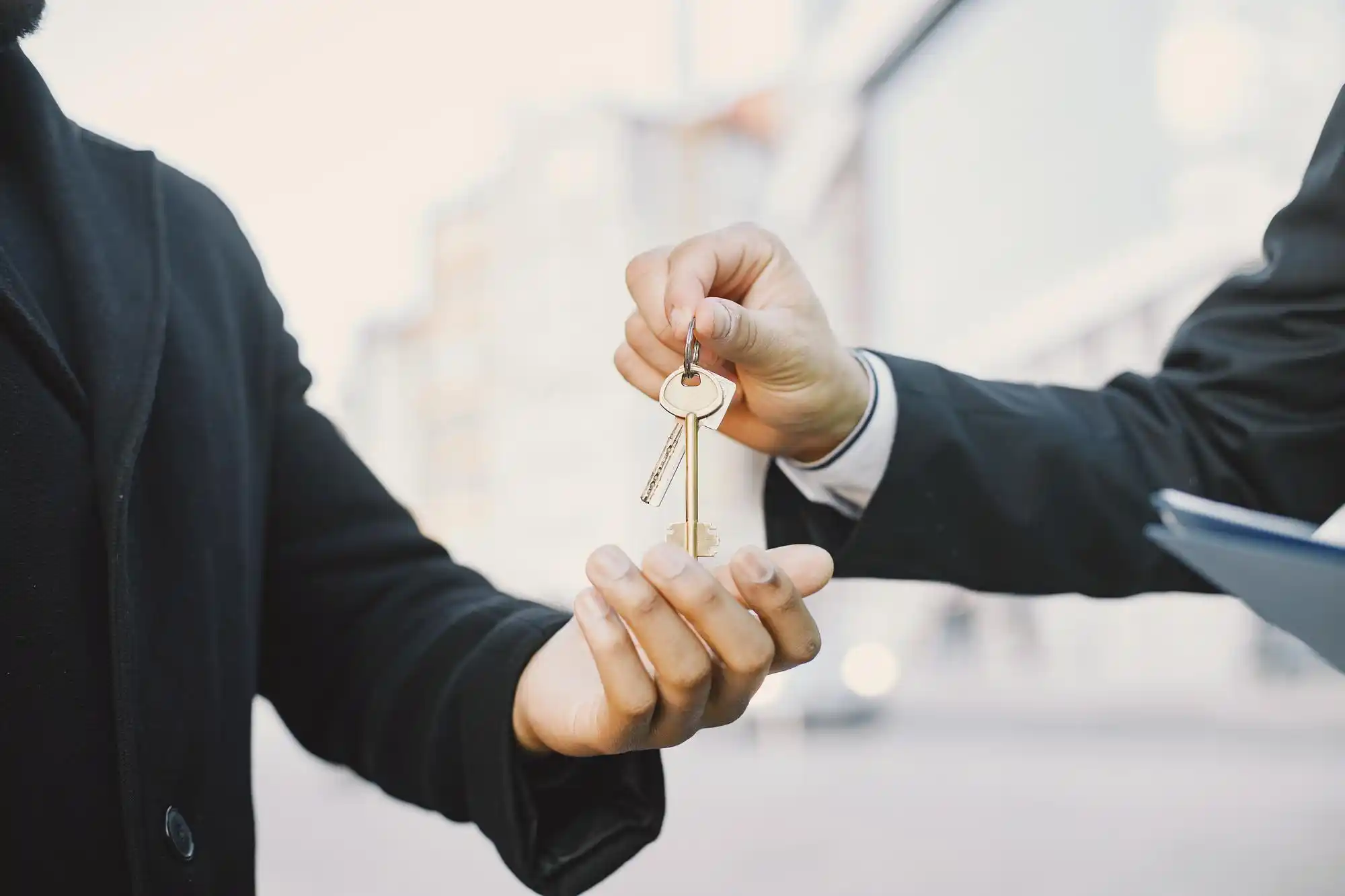 Real estate law banner, buying property concept with a man in uniform giving keys to another man.